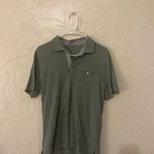 green Saks polo with white and blue floral pattern around neck and collar